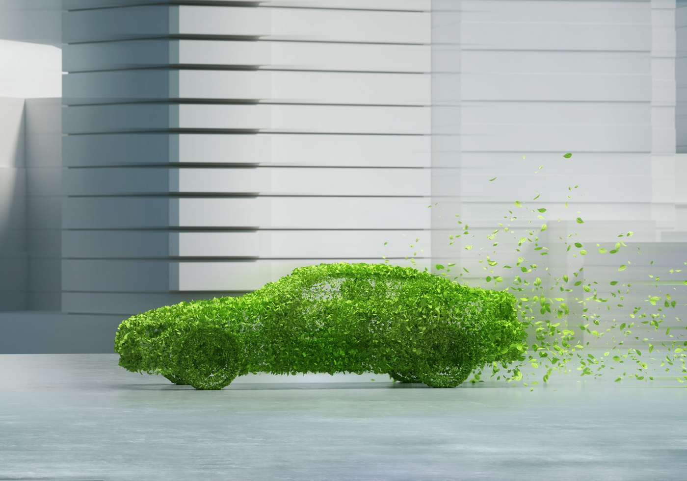 Das Bild zeigt ein Auto, das mit grünen Blättern bedeckt ist und sich langsam auflöst